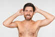 © InsideCreativeHouse - Beauty, hair and portrait of shirtless man in studio for grooming, personal hygiene or wellness. Face, shampoo and skincare with smiling model isolated on white background for haircare treatment