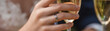 © wirachut - Engagement ring reality shines on hand holding glass authentic moment of celebration with sparkling diamond and elegant fingers