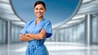 © Puttipong - Confident healthcare professional in blue scrubs standing with arms crossed, smiling in modern hospital environment, showcasing dedication to patient care