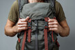 © beast01 - Hands adjust straps on backpack for better fit while preparing for outdoor activity
