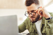 © Prostock-studio - Shocked Businessman Looking At Laptop Computer Above Eyeglasses Having Business Problem, Frowning And Reading Negative News Online Sitting Indoor. Selective Focus