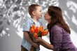 © BillionPhotos.com - Cute happy Child congratulating mom giving flowers.