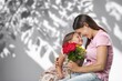 © BillionPhotos.com - Cute happy Child congratulating mom giving flowers.