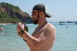© Jekaterina - Male tourist enjoying coconut water seaside holiday
