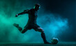 © ink drop - Football player running with ball through smoke and light effects showing strength and athletic performance
