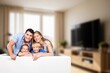 © BillionPhotos.com - Happy family sitting on the sofa smiling at camera