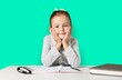 © BillionPhotos.com - Sad girl with hands on face sitting at deskbackground