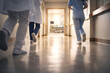 © おくや まさき - Medical Staff Rushing Through Hospital Corridor – Emergency and After-Hours Care（救急対応で廊下を走る医療スタッフ　夜間救急・休日診療の現場）