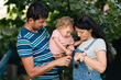 © Nikola Spasenoski - Parents Spending Time Together With Their Child Outdoors on a Sunny Day
