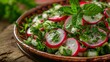 © Optimus  - Vibrant radish and mint salad with fresh herbs sits in an earthy brown bowl.