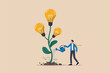 © Design gallery - Businessman watering a plant with light bulbs as flowers representing growth of ideas.