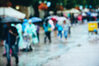 © Maksim Shebeko - Pedestrians joyfully navigate puddles, sheltered by colorful umbrellas from the rain