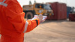 © Nattawit - An operation supervisor is writing on paper during perform safety audit at construction work site, with blurred background of heavy lifting operation. Industrial safe work practice concept scene.