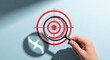 © fadillah - Hand holding magnifying glass over target aiming for business success.