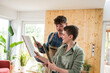 © Westend61 - Craftsman and woman discussing renovation with tiles at home