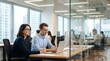 © CuteBee - A man and woman with glasses work intently on laptops and desktop computers in a bright, modern office environment.