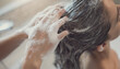 © Happy - Person shampooing hair in bathroom with foam. Suitable for beauty, hygiene, hair care, and personal grooming concepts. Ideal for promotional material.