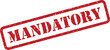 © designboundary - Grungy red mandatory stamp with a textured appearance on a plain white surface