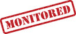 © designboundary - Grungy red monitored stamp with a textured appearance on a plain white surface