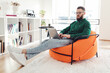 © Prostock-studio - Freelancer Guy Using Laptop Working Online Browsing Internet Sitting Indoors, Wearing Eyeglasses. Side View Shot. Internet And Technology. Freelance Career Concept.