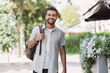 © kite_rin - Young student man in a city looking at camera, African-american businessman portrait, Confident men smiling outdoor, People lifestyle, city life, casual business concept