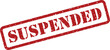 © designboundary - A prominent red grunge rubber stamp with the word SUSPENDED indicating a temporary halt or pause