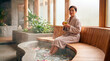 © Xenia - Relaxed Asian woman sitting by a foot bath in a luxury spa. Wellness and relaxation concept