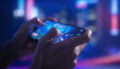 © Domurigu - Close-up of person's hands playing a video game on a mobile device with colorful bokeh lights in background