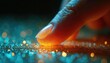© Vadym - Macro shot finger touching sparkling surface. Tiny bright particles glow with orange and teal light. Abstract textured background, bokeh effect and shine.