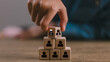 © Omid studio - business hand man put arranging on wooden cube block that family or company Succession business concept from old generation to next generation.