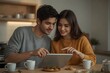 © João Macedo - A young couple in a modern kitchen, sharing a tablet, are pointing to a graph showing the growth of compound interest.