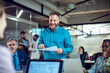 © Marko Geber - Smiling manager leading team meeting in modern open office