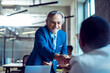 © Marko Geber - Senior businessman shaking hands in modern office