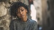 © Oleksandr - Quiet moment outside in a stone corridor featuring a casually dressed Black woman