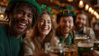 © INSPIRIA.K - Group of happy friends, a man and a woman, celebrating Saint Patricks Day in a lively pub, enjoying beer and good company with a cheerful atmosphere.