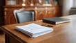 © Bussakon - A professional office scene with a desk holding papers a book and a pen