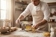© Stitch - A chef in an apron making fresh pasta from scratch using a pasta machine on a floured wooden table.