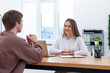 © New Africa - Smiling recruiter and candidate having job interview at table in office