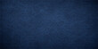 © MasterCrafted - A closeup of a dark indigo denim fabric material with a rough blue leather texture and a textured cotton canvas pattern for a fashion clothing background