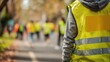 © Luminostock 54 - leadership  development nonprofits  volunteer concept. Person wearing a reflective safety vest standing on a blurred outdoor path.