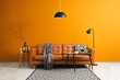 © Pixel-Shot - Interior of stylish living room with brown sofa, coffee table and standard lamp near orange wall