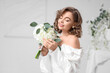© Pixel-Shot - Beautiful bride with flowers in room