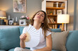 © Graphicroyalty - Hot flash. Menopause symptoms, Woman with overheating problem, Healthcare and medicine concept. Attractive lady sitting on sofa and cooling herself with a hand fan while feeling sweat and fever.