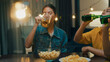 © tirachard - Group of multiethnic young adult Asia friend drinking alcohol beer bottle glass and having fun laugh enjoy hangout party in night life indoor home. Happy hour time millennial generation inside house.