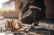 © standret - Sitting and using leveling tool. Builder is working on construction site, unfinished building