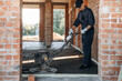© standret - Process of leveling the concrete on the floor. Builder is working on construction site, unfinished building