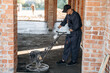 © standret - Holding the device for leveling the floor, concrete. Builder is working on construction site, unfinished building