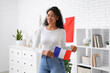 © Pixel-Shot - Beautiful young happy African-American woman with flags of France at home