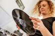 © Westend61 - Close-up of mid adult woman holding record at home