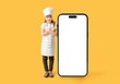 © Pixel-Shot - Cute little chef and big mobile phone with blank screen on yellow background